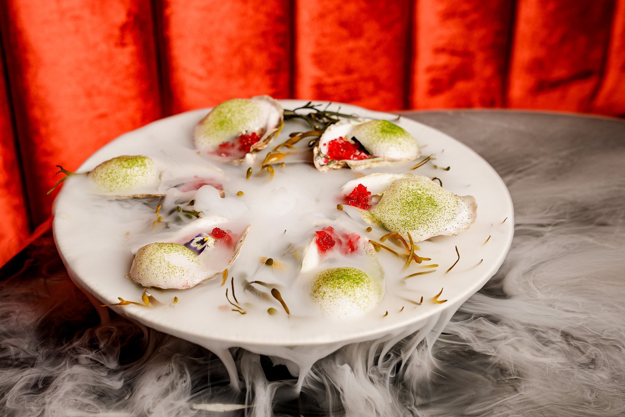 Unique vintage cocktails served with dry ice on a white platter at the cozy bar Room 207 in East Village.